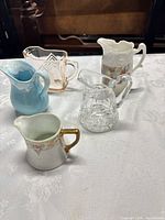 Group shot of all five creamers on table