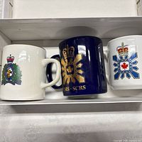 Three commemorative mugs in original box