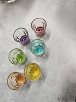 Top view of six colored base faceted shot glasses