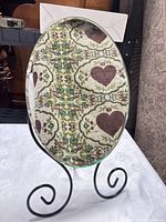 front view of oval mirror on scroll stand