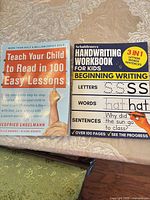 Front covers of Teach Your Child to Read in 100 Easy Lessons and Scholdeners Handwriting Workbook for Kids