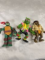 Three TMNT figures standing side by side