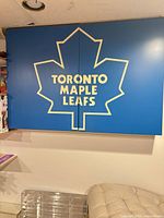 Front view of two-panel sign showing full logo