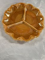 Top view showing three compartments, marigold color, ruffled rim