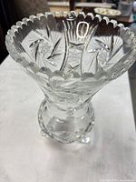Full view of cut crystal vase showing pattern and scalloped rim