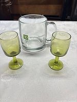 Two green cordial glasses and clear TD Waterhouse mug group shot