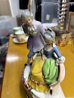 Front view showing porcelain couple and clock housing