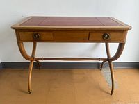 front view of wooden Directoire style desk with two drawers and curved legs