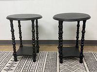 Both round matte black end tables side by side showing overall design