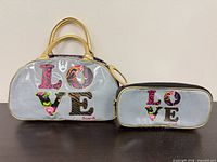 Satchel handbag and zip pouch front view showing LOVE motif and relative sizes