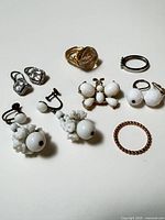 Entire lot laid out showing all earrings, rings and brooch