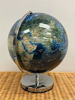 Full view of illuminated globe showing Europe, Asia, chrome meridian and base