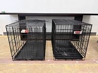 Both wire dog crates side by side showing overall condition and size