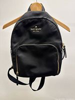 Front view of black Kate Spade backpack on hanger