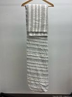 Folded duvet cover and sham hanging to show texture