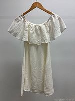 front view of white off-shoulder dress on hanger