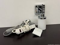 all items: chrome wall sconce, white power strip, grey power strip, white wall tap