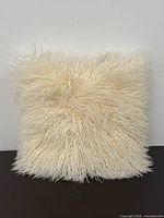 Front view of cream Mongolian lamb pillow