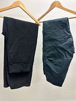 Both pairs of pants hanging side-by-side showing overall style and colours