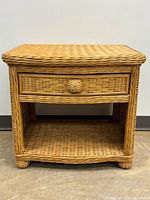 Front view showing drawer, shelf, bun feet