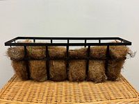 Front view of rectangular metal balcony planter with coir liner
