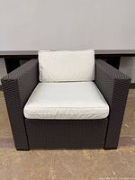 Front view of wicker lounge chair with cushions