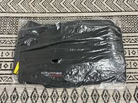 Sealed package showing full set of black floor mats