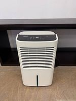 Front view showing louvered intake, water tank and level window