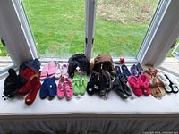 Overview of all footwear lined on window seat