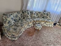 Entire sectional assembled showing floral fabric and footstool