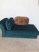 Full view of green velvet chaise lounge with accent pillow