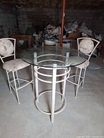 Round glass top bistro table with two matching chairs