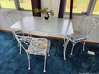 Table and three of four chairs showing overall set