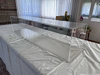 Full view of clear acrylic display case on table