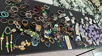 overview of entire jewelry lot spread across two tables