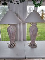 Front view of both matching pink leaf ceramic lamps with shades