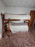 Front angled view of wooden bunk bed frame showing ladder, top and bottom bunks