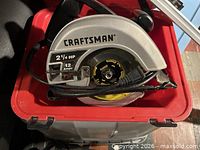 Close-up of Craftsman circular saw showing branding, power rating and blade size inside red case
