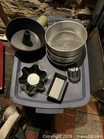 Multiple cake pans and molds on tote lid