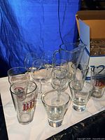 Full view of pitcher, wine, pint, and martini glasses grouped on table