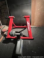 Ascent red bike trainer stand front view with resistance unit