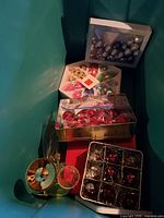 Overview of items in tote including ornament boxes and tins