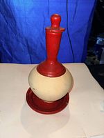 bottle assembled with stopper on saucer, front view