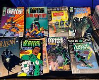 Eight comic books laid out including several Green Lantern titles, Silver Age Classics Detective Comics reprint, Green Hornet and others