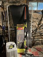 Full set showing trimmer poles, battery, charger and box