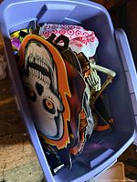 Purple tote containing assorted Halloween items