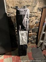Black wheeled carry bag standing upright