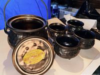 open tureen showing interior, lid underside with McCoy label, four footed bowls