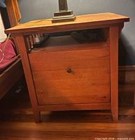 Front view of mission style oak cabinet with single drawer