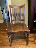 Full front view of pine chair showing slatted back, turned legs, overall form